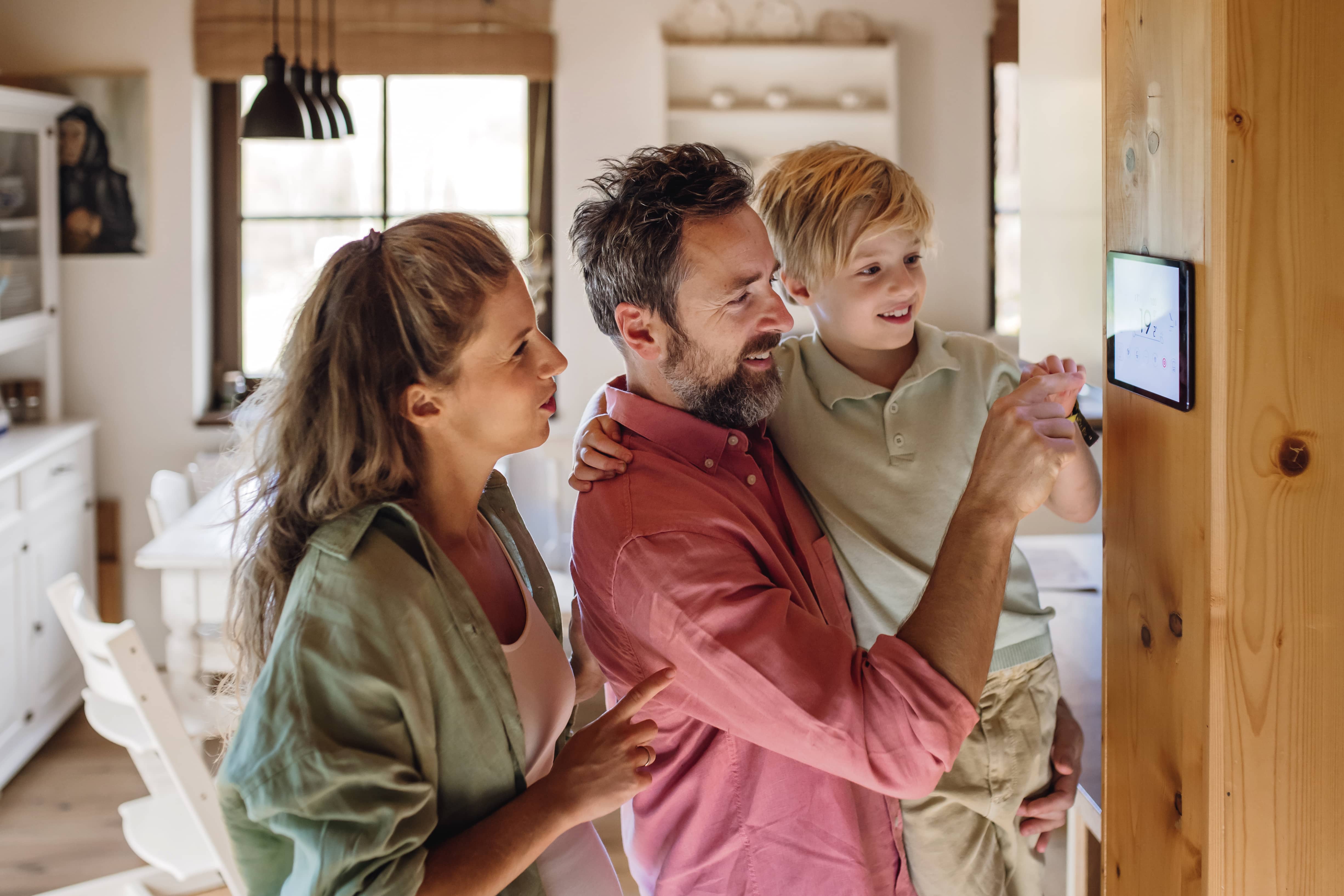 A family changing their thermostat.